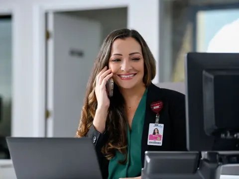 Health navigator on the phone helping patient.