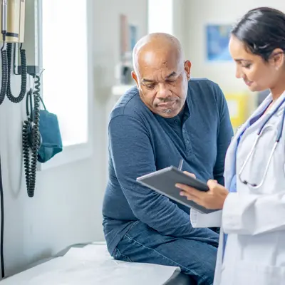 A middle-aged man talking to his doctor.