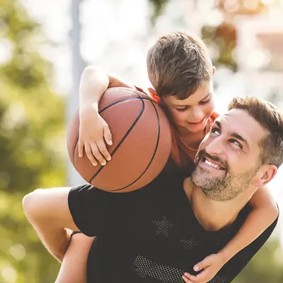 A man holding his son on his shoulders.