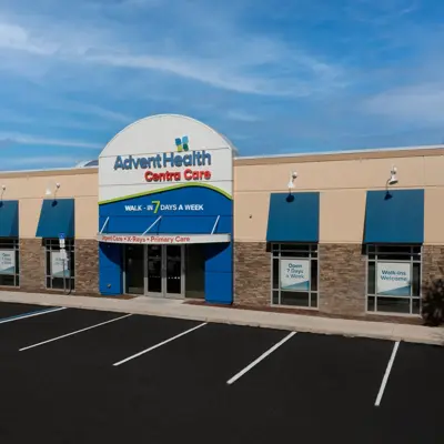 AdventHealth Centra Care building with blue awnings and open signs, inviting walk-ins.