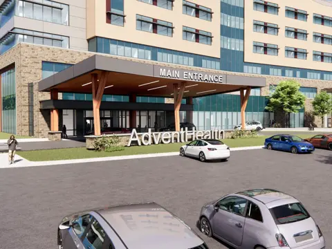 Architectural rendering of an AdventHealth facility main entrance with a covered drive-through canopy, large white AdventHealth signage in the foreground, and a multi-story hospital building with beige and glass exterior