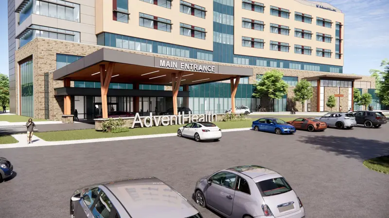Architectural rendering of an AdventHealth facility main entrance with a covered drive-through canopy, large white AdventHealth signage in the foreground, and a multi-story hospital building with beige and glass exterior
