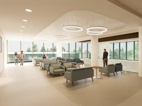 Modern hospital waiting area with contemporary seating arrangements, circular pendant lighting, floor-to-ceiling windows overlooking trees, and a textured stone accent wall