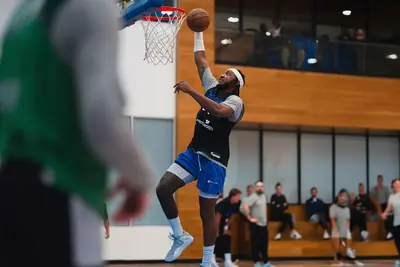 An Orlando Magic player dunking a basketball.