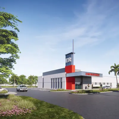 Architectural rendering of a standalone emergency department with an ER entrance, surrounding parking, landscaped grounds, and a clear blue sky.