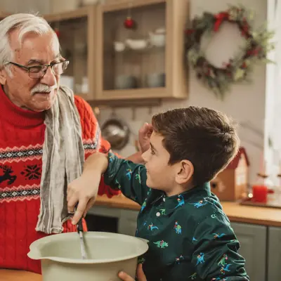 A Grandfather teaches his grandson how to cook.