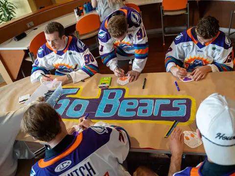 The Orlando Solar Bears coloring-in logos on a table.