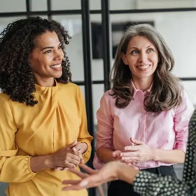 Three woman having a conversation.