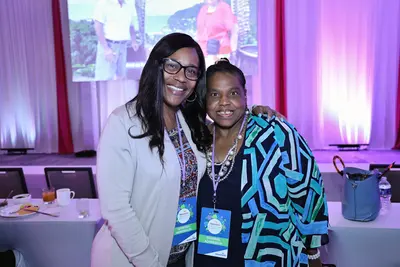 Two women smiling together at the AdventHealth Women’s Health and Cancer Prevention Event.