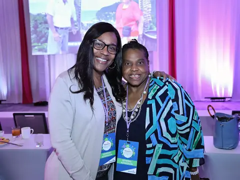 Two women smiling together at the AdventHealth Women’s Health and Cancer Prevention Event.