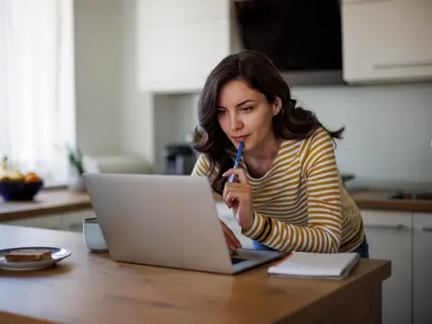 Young woman using a laptop while working from home.