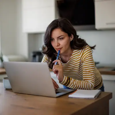 Young woman using a laptop while working from home.