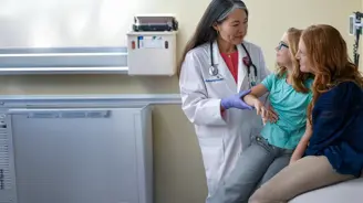 AdventHealth Centra Care physician in white coat examining a young girl's arm while her mother watches during a consultation in a clinic room