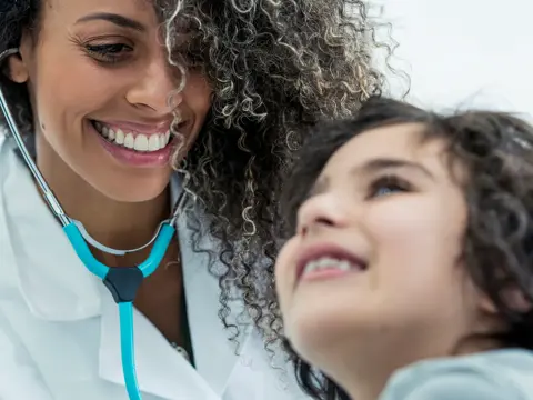 A female physician with a child patient.