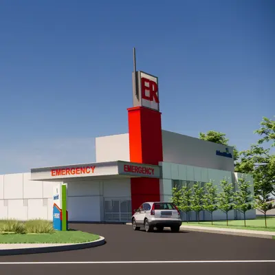 Architectural rendering of AdventHealth Auburndale Emergency Room facility exterior with prominent red ER tower, white building facade, and landscaped entrance