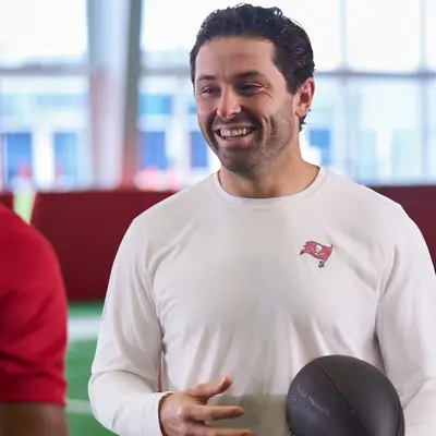 Tampa Bay Buccaneers Quarterback Baker Mayfield holds a football at their indoor practice facility.