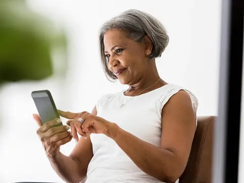 An older woman using her cell phone.