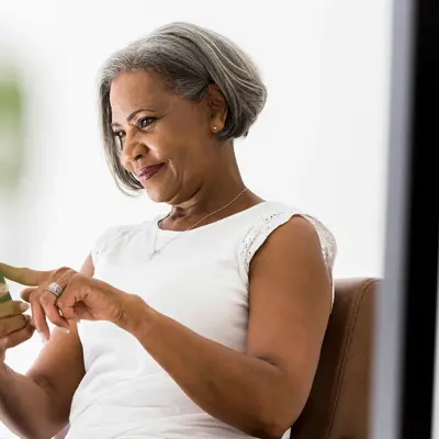 An older woman using her cell phone.