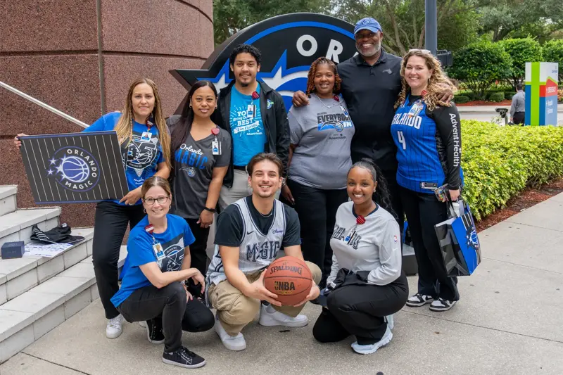 A group of people wearing Orlando Magic gear.