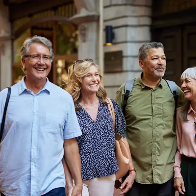 A middle-aged group of people walking through the city.