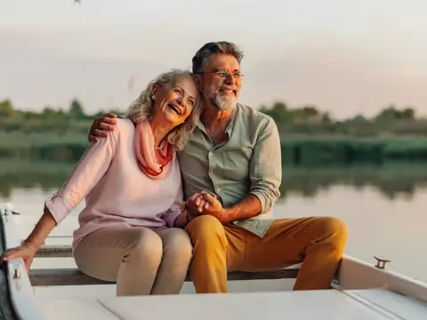 An older couple sitting in a boat.