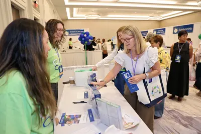 Attendee gathering health information from AdventHealth team members at the Women’s Health and Cancer Prevention Event.
