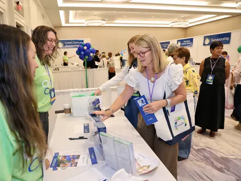 Attendee gathering health information from AdventHealth team members at the Women’s Health and Cancer Prevention Event.