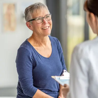 An older woman speaking to her doctor.