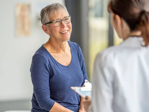 An older woman speaking to her doctor.