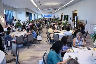 Attendees dining and socializing at the AdventHealth Women's Health and Cancer Prevention Event.