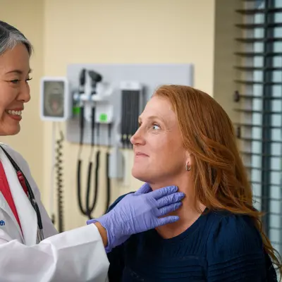 A Doctor Checks a Patient's Throat with a Physical Exam