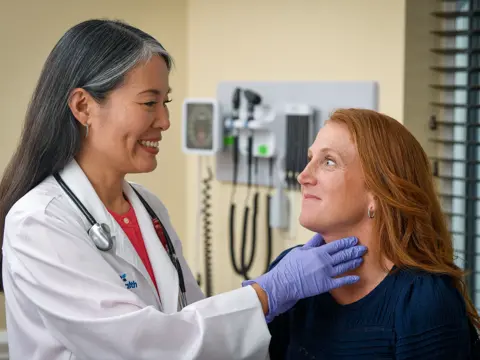 A Doctor Checks a Patient's Throat with a Physical Exam