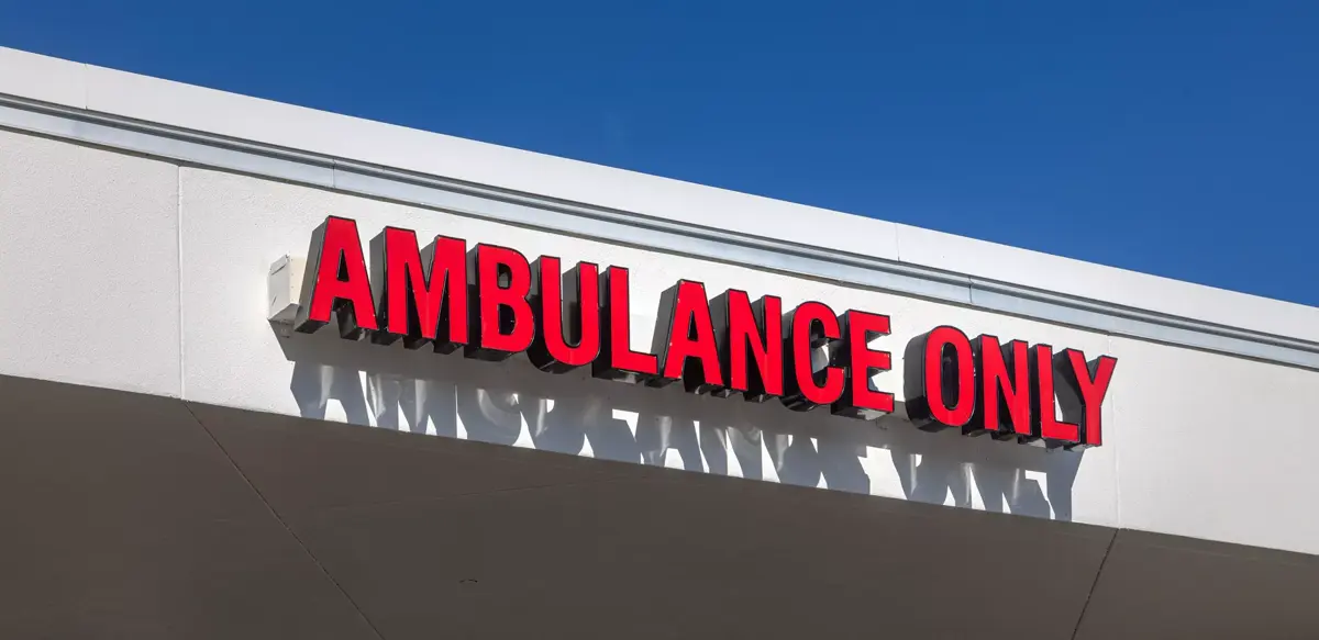 Red sign on a building reads 'Ambulance Only' in bold letters.