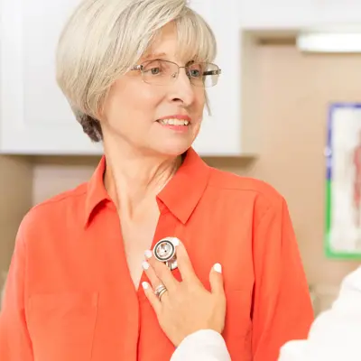 An older woman speaking with her healthcare provider.