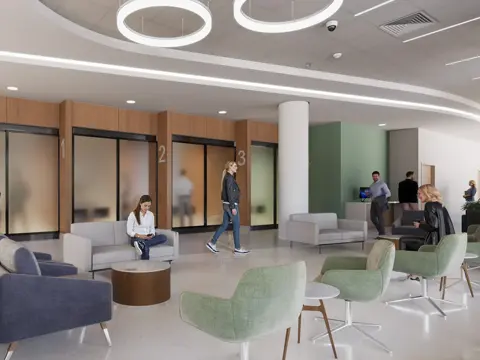 A modern health care facility registration area with numbered consultation rooms, comfortable seating in gray and green tones, and natural wood accents throughout the waiting space