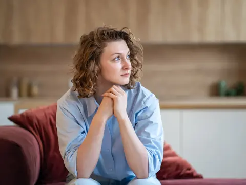 A young woman looking apprehensive.