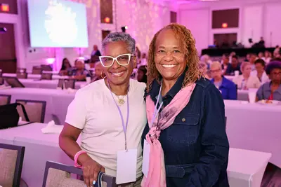 Two women smiling together at the AdventHealth Women’s Health and Cancer Prevention Event.