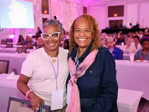 Two women smiling together at the AdventHealth Women’s Health and Cancer Prevention Event.