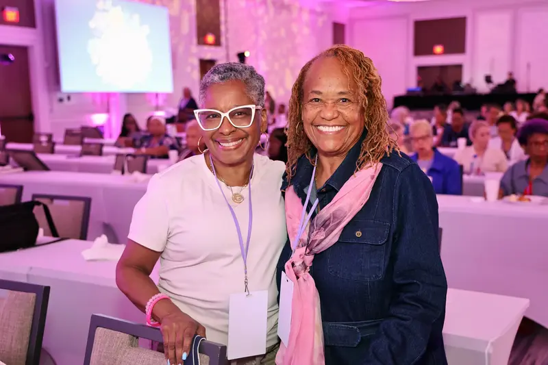 Two women smiling together at the AdventHealth Women’s Health and Cancer Prevention Event.