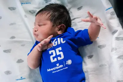 A baby wearing an Orlando Magic shirt.