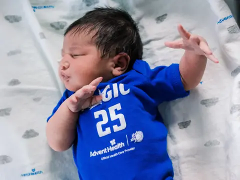 A baby wearing an Orlando Magic shirt.