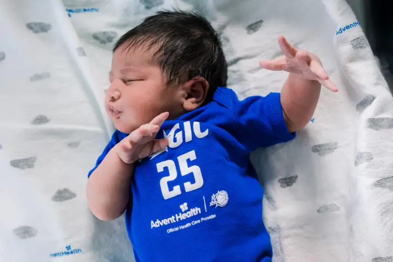 A baby wearing an Orlando Magic shirt.