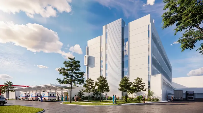 Exterior architectural rendering of the AdventHealth Carrollwood Garden Tower expansion showing a modern multi-story medical facility with white facade, landscaped grounds, ambulance bay, and people walking near the entrance