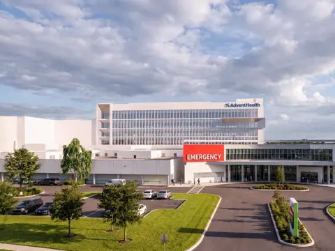 Architectural rendering of the AdventHealth Carrollwood Garden Tower expansion featuring a modern multi-story medical facility with emergency entrance and landscaped grounds
