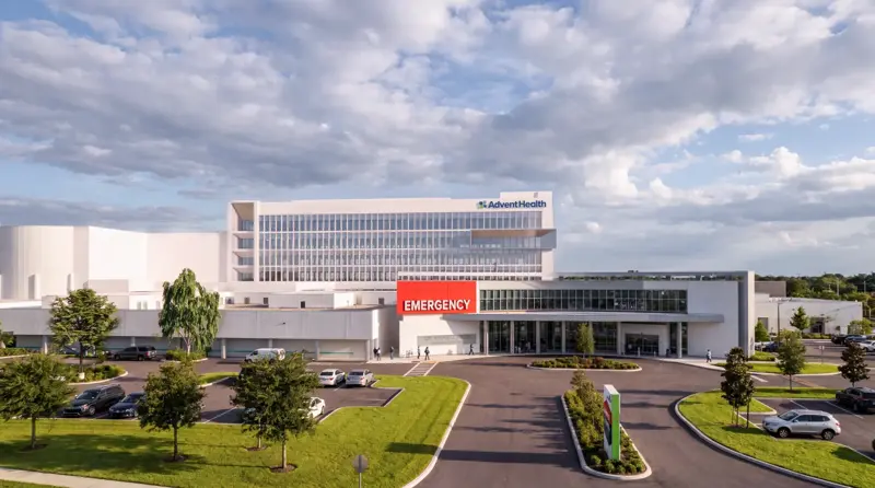 Architectural rendering of the AdventHealth Carrollwood Garden Tower expansion featuring a modern multi-story medical facility with emergency entrance and landscaped grounds
